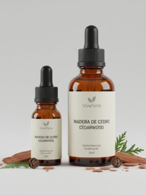 Two amber glass bottles (10ml and 30ml) with matte black pipettes. Labels show the VivaForte logo and the titles "MADERA DE CEDRO" and "CEDARWOOD." Wood chips and cedar sprigs are scattered on a neutral background.